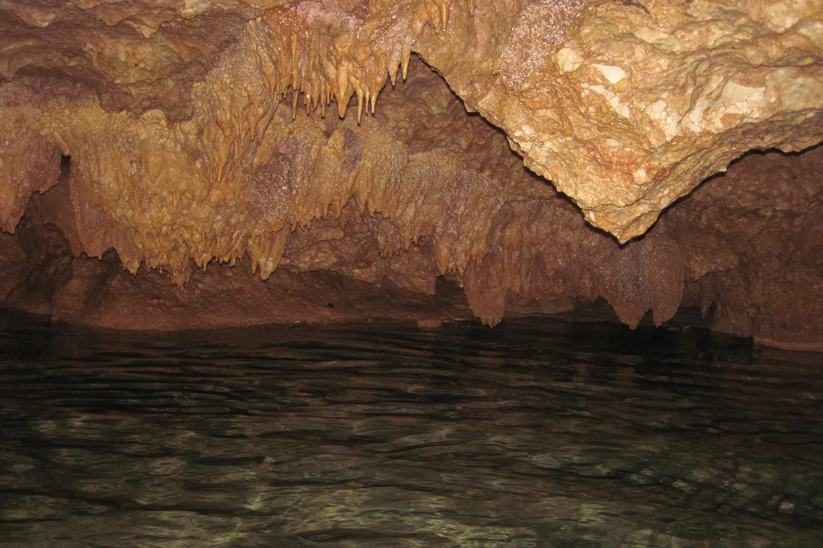 A low hanging ceiling inside of the cave system at Actun Tunichil Muknal “ATM Cave” at Umaya Resort & Adventures