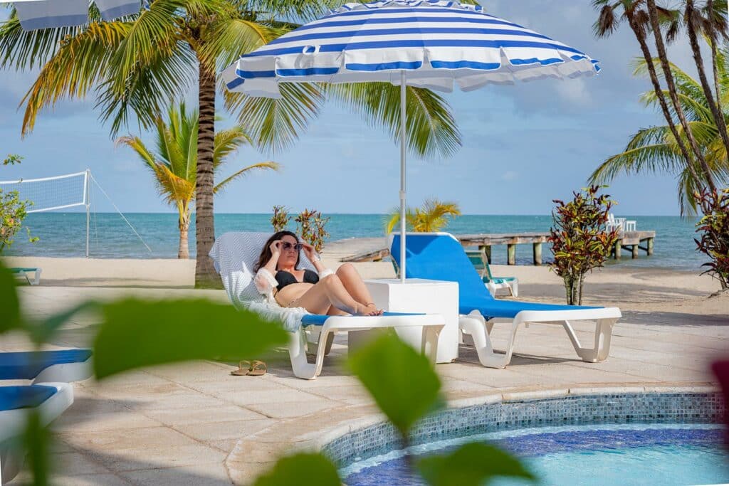 A guest sitting on a chair by the poolside at Umaya beach