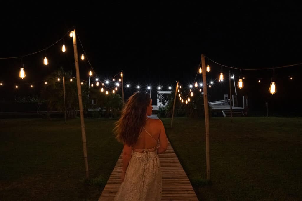 A guest walking on the boardwalk on the lagoon side at Umaya