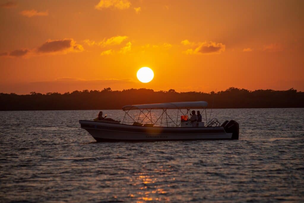 A guest in a boat on the sunset cruise