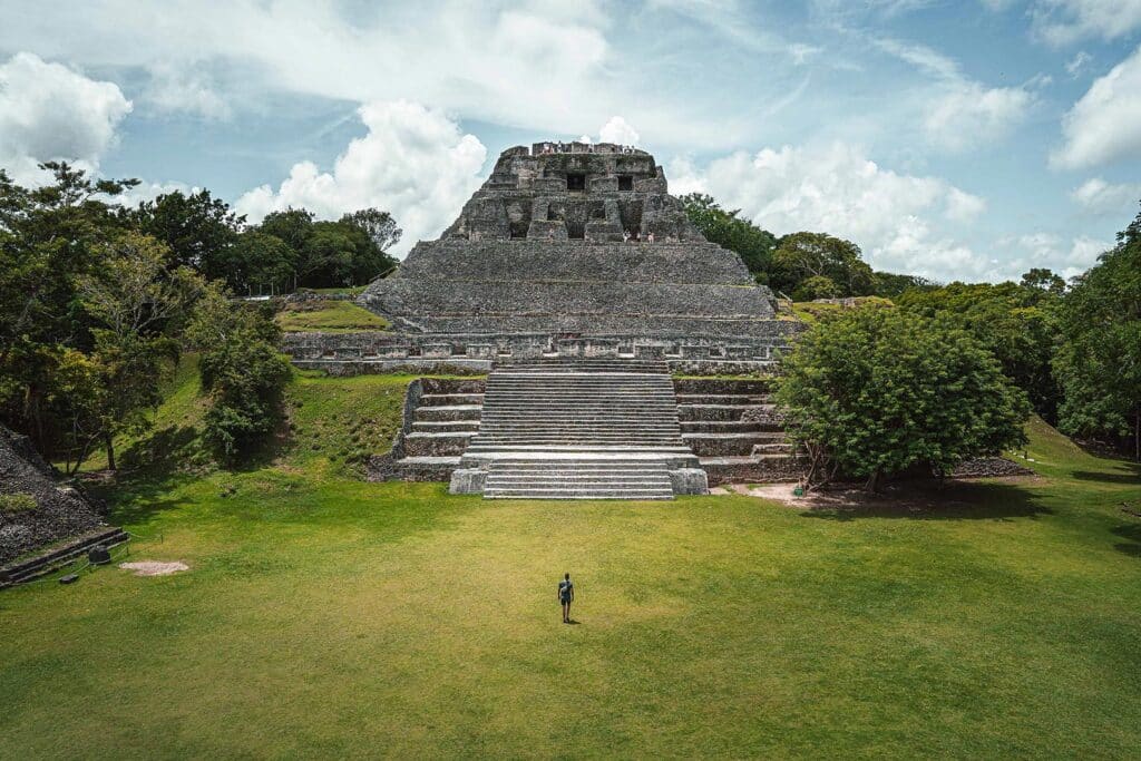 A man waling towards a mayan temple at Xunantunich