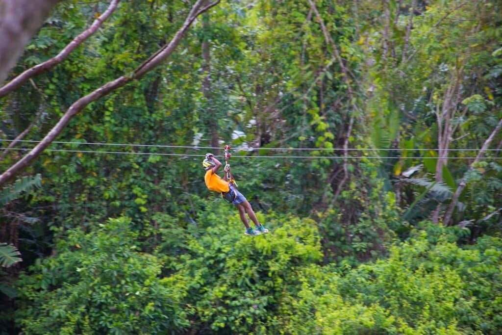 A man gilding through the ziplines